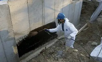 Professional waterproofing the exterior walls of the basement in Wichita, KS