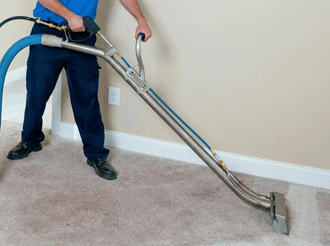 Professional operating a liquid removal machine on a carpeted floor in Wichita, KS
